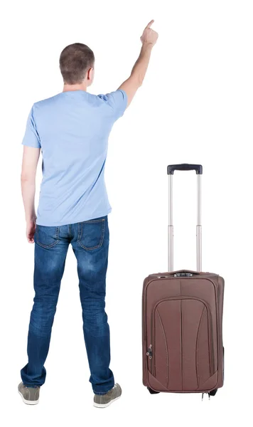 Back view of pointing young men traveling with suitcase . — Stock Photo, Image