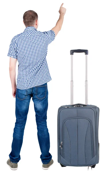 Back view of pointing young men traveling with suitcase. — Stock Photo, Image