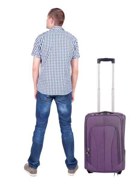 Back view of young man traveling with suitcase. — Stock Photo, Image