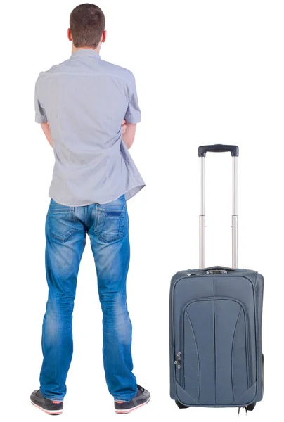 Back view of young man traveling with suitcase. — Stock Photo, Image