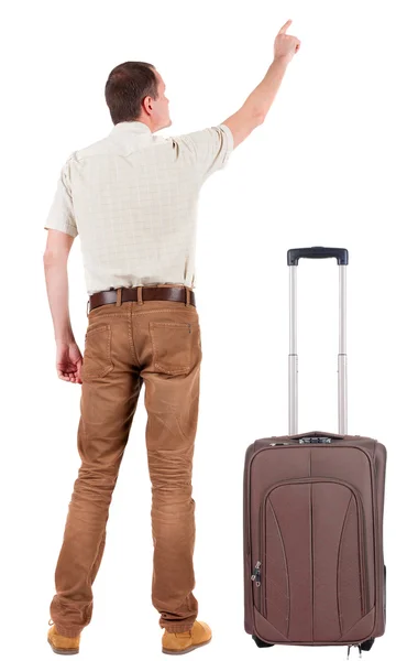 Back view of pointing young men traveling with suitcase. — Stock Photo, Image