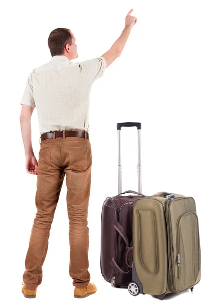 Back view of pointing young men traveling with suitcase. — Stock Photo, Image
