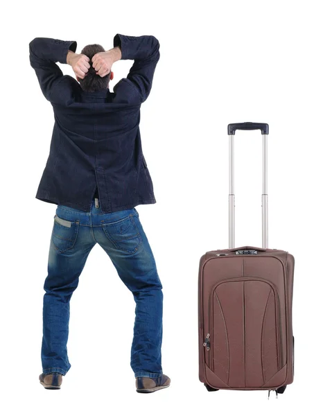Сердитый молодой человек с чемоданом — стоковое фото