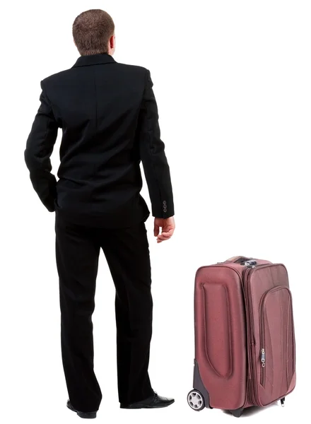 Back view of business man in black suit traveling with suitcase. — Stock Photo, Image