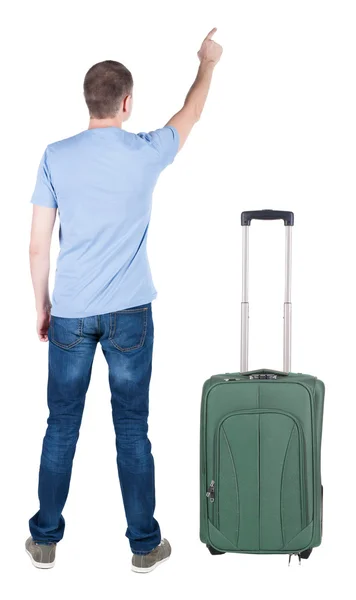 Back view of pointing young men traveling with suitcase. - Stock-foto