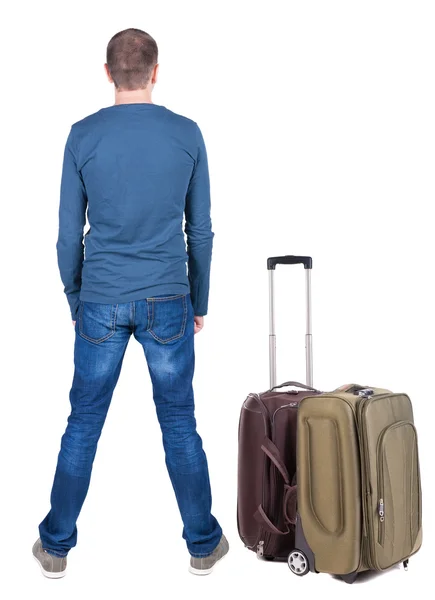 Bakifrån av ung man reser med resväska. — Stockfoto