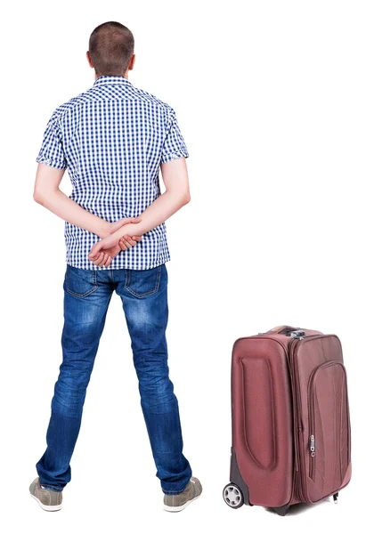 Back view of young man traveling with suitcase. — Stock Photo, Image