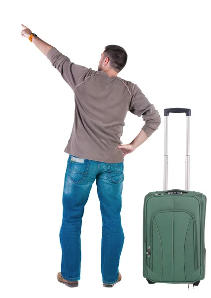 Back view of pointing young men traveling with suitcase. — Stock Photo, Image