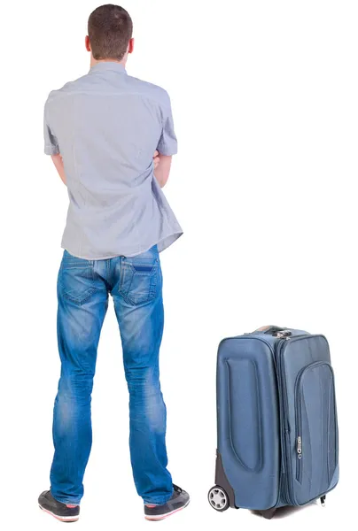 Back view of young man traveling with suitcase. — Stock Photo, Image