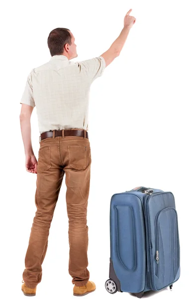 Back view of pointing young men traveling with suitcase. — Stock Photo, Image