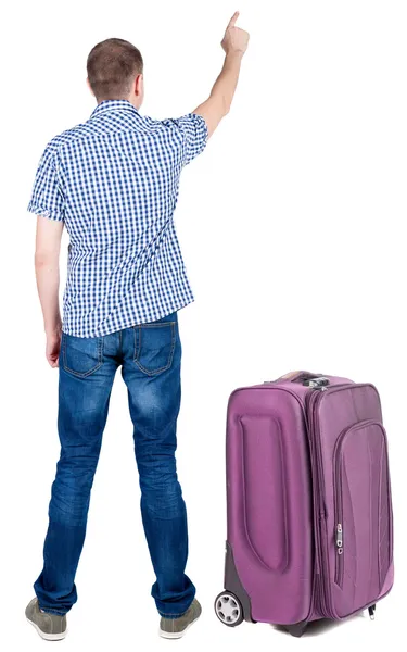 Back view of pointing young men traveling with suitcase. — Stock Photo, Image