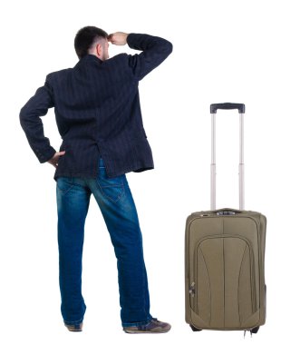 genç adam ile bavul seyahat önde görünüyor. arka görünüm.