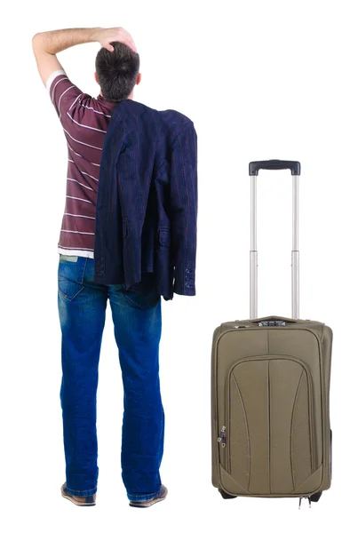 Jonge man met koffer reizen kijkt vooruit. Achteraanzicht. — Stockfoto