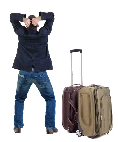 Angry young man traveling with suitcase — Stock Photo, Image