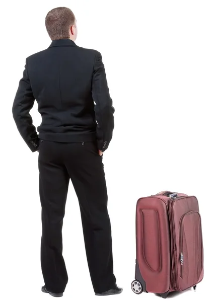 Back view of business man in black suit traveling with suitcase . — Stock Photo, Image