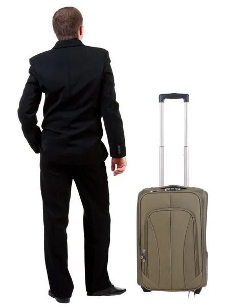 スーツケースと一緒に旅行黒のスーツのビジネスマンの背面図 . — ストック写真