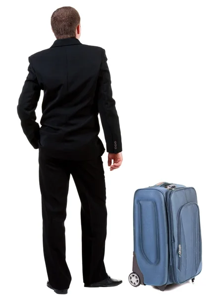 Widok człowieka biznes czarny garnitur z walizka z tyłu . — Zdjęcie stockowe