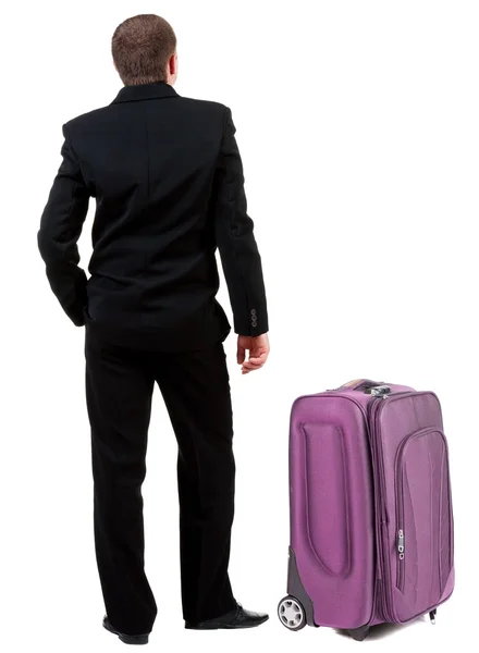 Back view of business man in black suit traveling with suitcase . — Stock Photo, Image