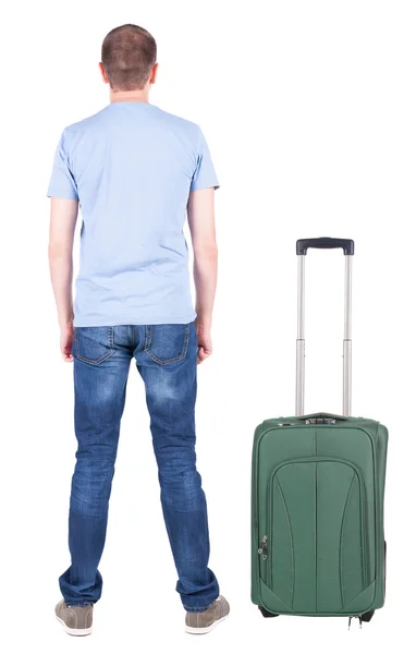 Pohled zezadu na mladého muže s kufrem. — Stock fotografie