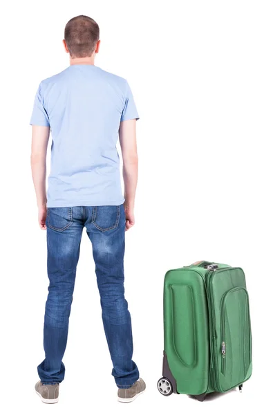 Back view of young man traveling with suitcase. — Stock Photo, Image