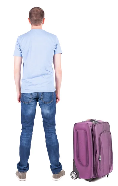 Back view of young man traveling with suitcase. — Stock Photo, Image