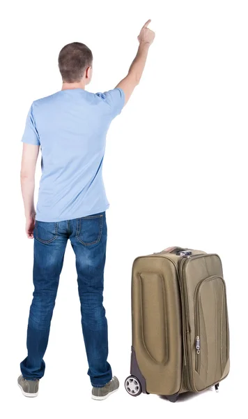 Arkadan görünüş-genç erkek ile bavul seyahat işaret. — Stok fotoğraf