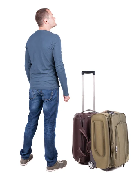 Back view of young man traveling with suitcase. — Stock Photo, Image