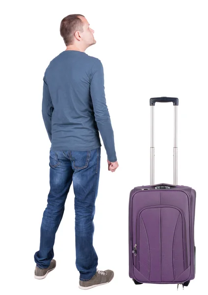 Back view of young man traveling with suitcase. — Stock Photo, Image