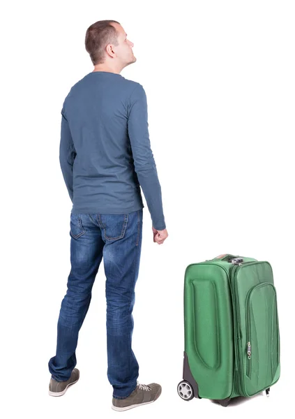 Bakifrån av ung man reser med resväska. — Stockfoto
