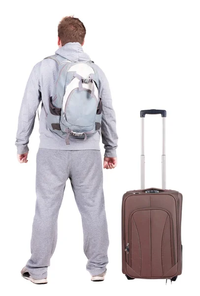 Back view of young man traveling with suitcase. — Stock Photo, Image