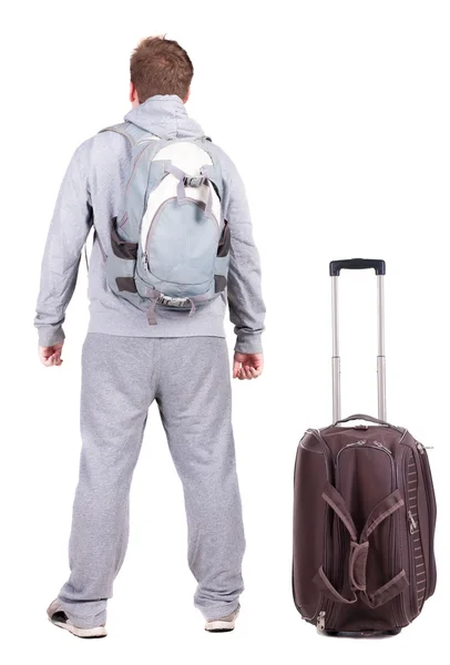 Back view of young man traveling with suitcase. — Stock Photo, Image