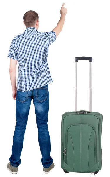 Back view of pointing young men traveling with suitcase. — Stock Photo, Image