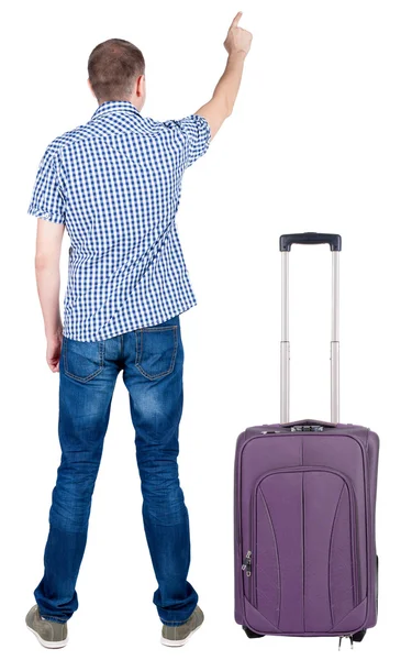 Back view of pointing young men traveling with suitcase. — Stock Photo, Image