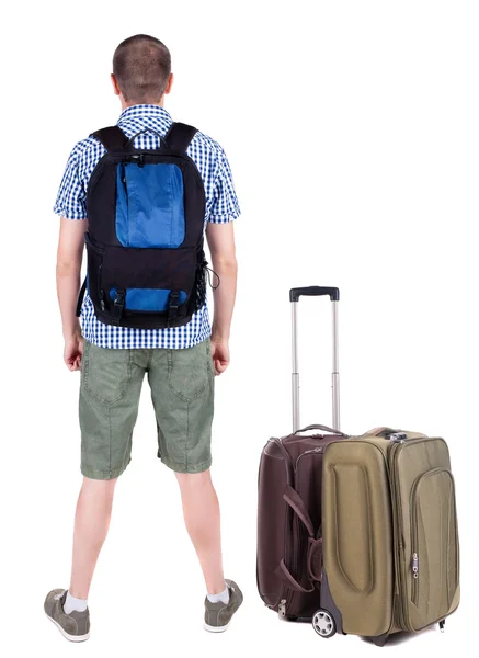 Back view of young man traveling with suitcase. — Stock Photo, Image