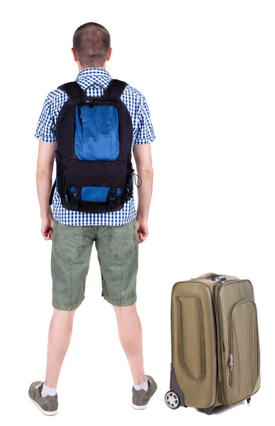 Rückansicht des jungen Mannes Reisen mit Koffer. — Stockfoto