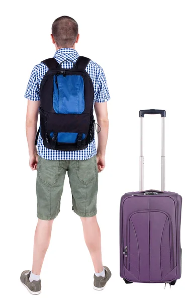 Back view of young man traveling with suitcase. — Stock Photo, Image