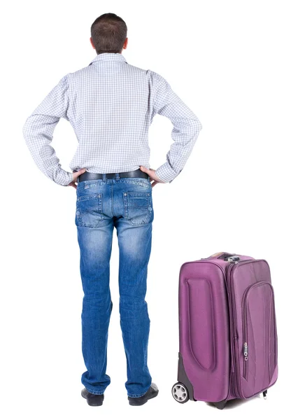 Back view of young man traveling with suitcase. — Stock Photo, Image