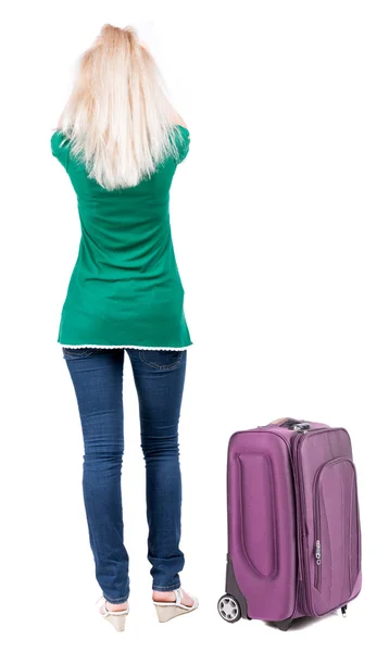 Back view of standing young beautiful blonde woman with suitcase — Stock Photo, Image
