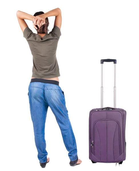 Back view of standing young beautiful brunette woman with suitcase — Stock Photo, Image