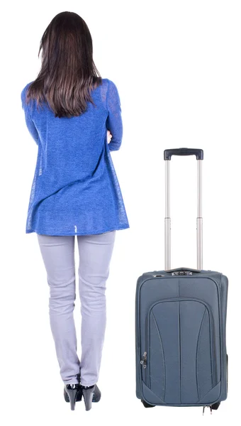 Back view of standing young beautiful brunette woman with suitcase — Stock Photo, Image