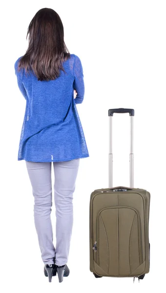 Back view of standing young beautiful brunette woman with suitcase — Stock Photo, Image