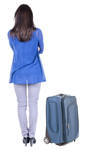 Back view of standing young beautiful brunette woman with suitcase — Stock Photo, Image