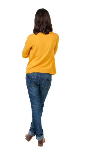 Back view of standing young beautiful brunette woman in yellow — Stock Photo, Image