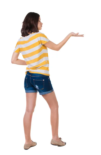 Back view of beautiful woman in jeans shorts holds hand up. — Stock Photo, Image