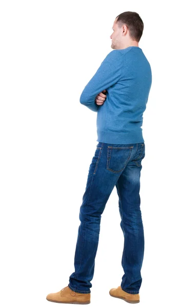 Back view of handsome man in blue pullover looking up. — Stock Photo, Image