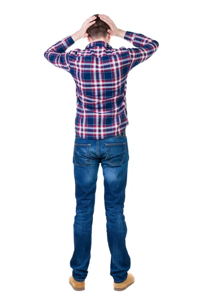 Back view of angry young man in jeans and checkered shirt — Stock Photo, Image