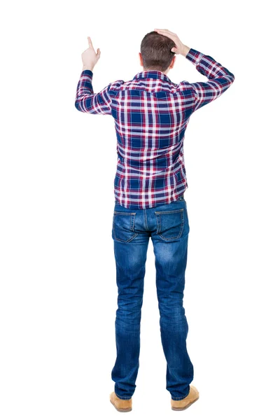 Back view of angry young man in jeans and checkered shirt — Stock Photo, Image