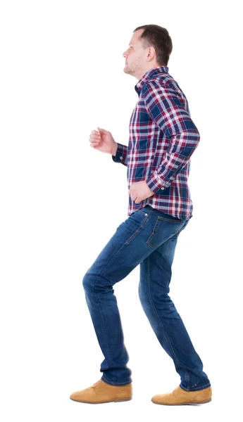 Pohled zezadu na běžící muž v kostkované košili. — Stock fotografie