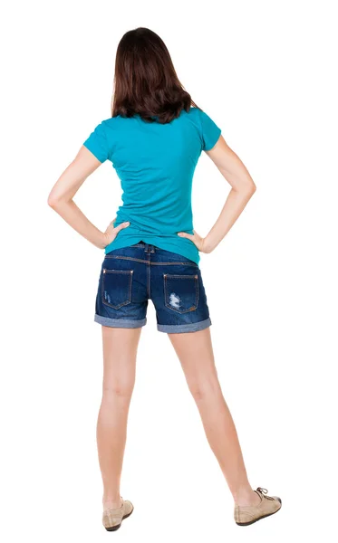 Back view of standing young beautiful brunette woman in shorts. — Stock Photo, Image