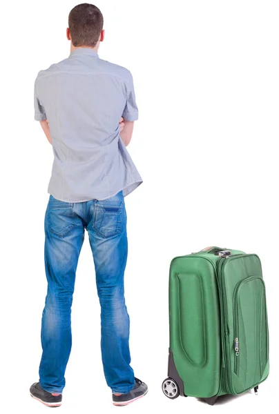 Back view of young man traveling with suitcase. — Stock Photo, Image